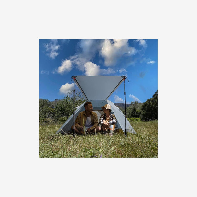 Campers setting up the P Series 2P tent in a forest or mountain campsite