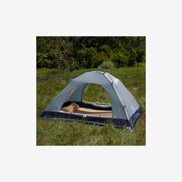 Campers setting up the P Series 2P tent in a forest or mountain campsite