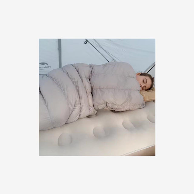 Camper or guest sleeping on C20 mattress inside a tent or guest room