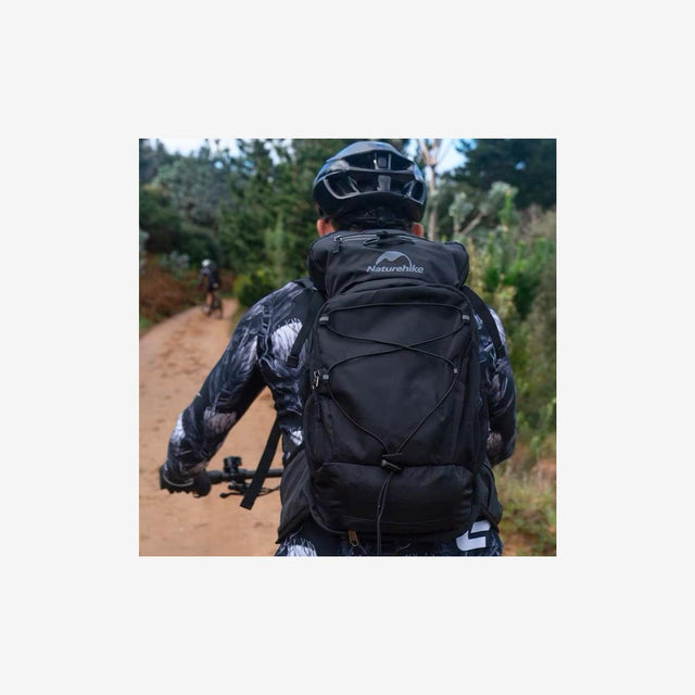 Cyclist wearing Naturehike Cielo backpack on a mountain trail