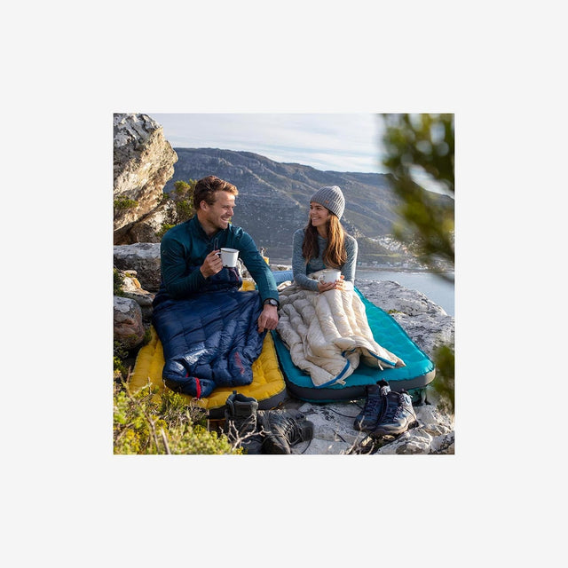 Backpacker using a Naturehike CW280 sleeping bag at a summer campsite