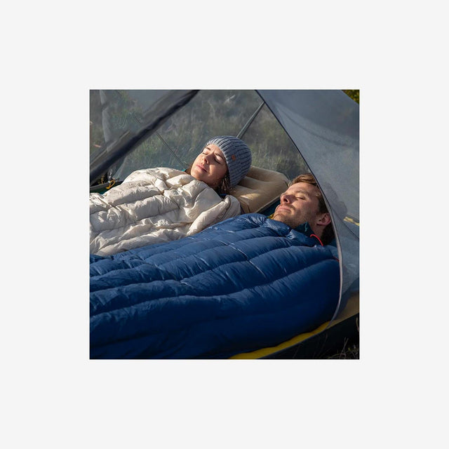 Backpacker using a Naturehike CW280 sleeping bag at a summer campsite