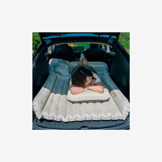 resting on inflated mattress in car while camping