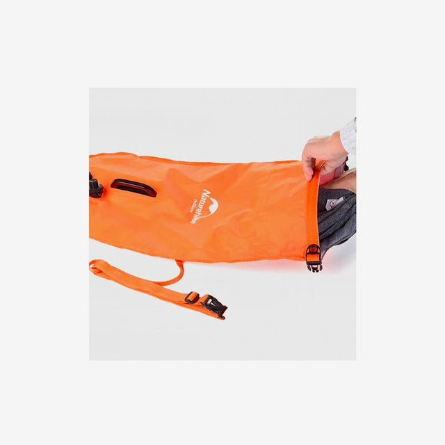 Tote bag packed with clothes, towel, and beach essentials