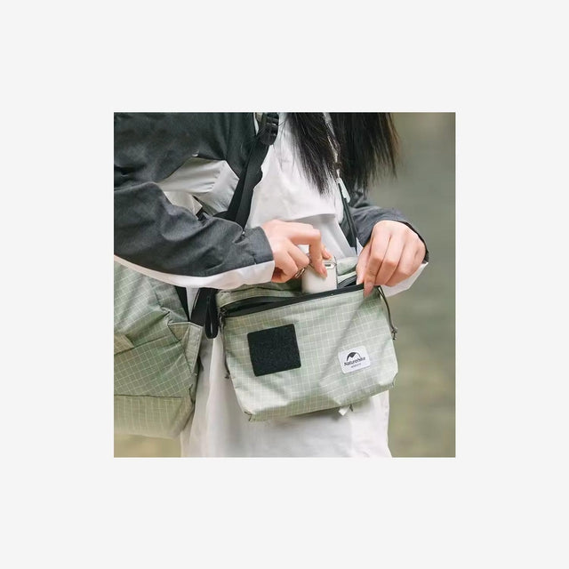 Traveler wearing Naturehike 3L messenger bag during city exploration