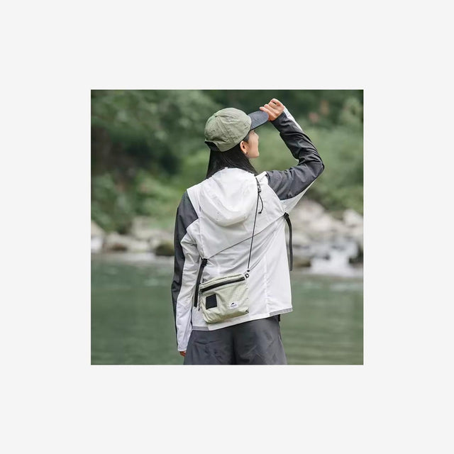 Traveler wearing Naturehike 3L messenger bag during city exploration