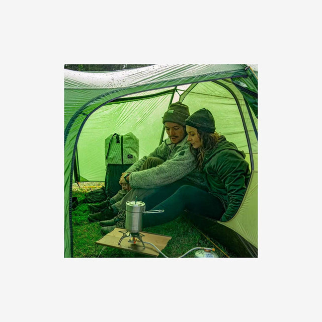 Campers setting up the Opalus 3P tent on a mountain or forest campsite