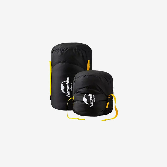 Compression bag packed with sleeping bag and cinched down to minimal size