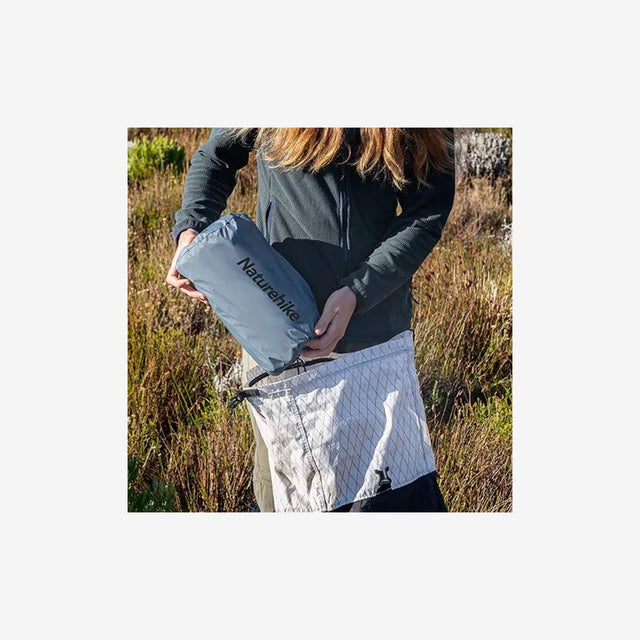 Pad rolled and secured with straps inside compact storage pouch