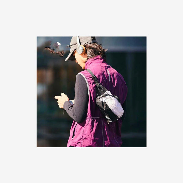 Hiker wearing cross-body chest bag during an outdoor trek