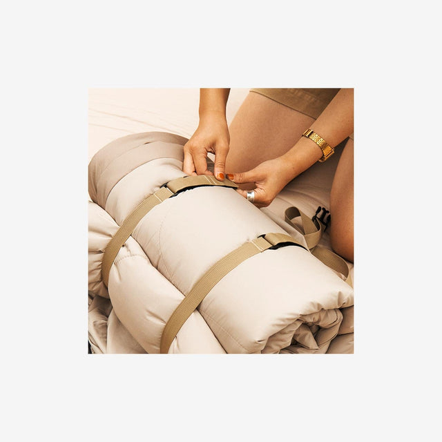 Oval sleeping bag packed neatly into its carry bag